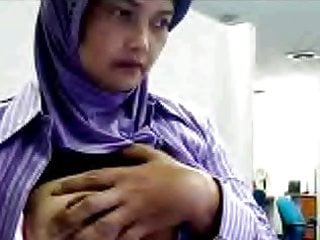 Indonesian house wife yoli with hijab playing boobs