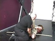 Lovely young slave girl in lingerie is restrained in the sex basement by master