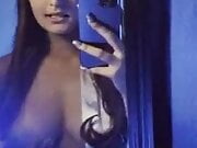 Agreeable sexy brunette and her smartphone 