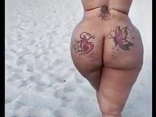 Ebony chick walking naked beach...