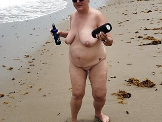Happy wife dancing nude at a nude beach in florida