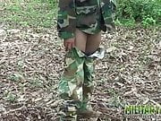 Army boy strokes his wood in the woods