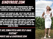 Sindy Rose, prolapse, blue sky, corn field and self anal fis