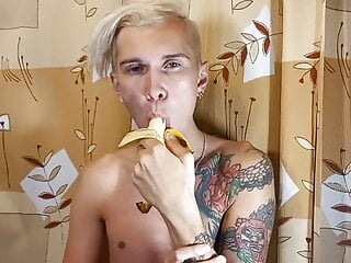 Sweet boy eats a banana greedily...