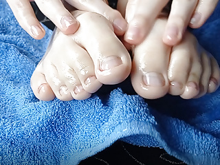 Foot Fetish. Girl With Crossed Fingers Massage Feet With Oil