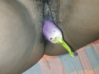 My tight pussy is being pampered with a brinjal. It hurts a bit